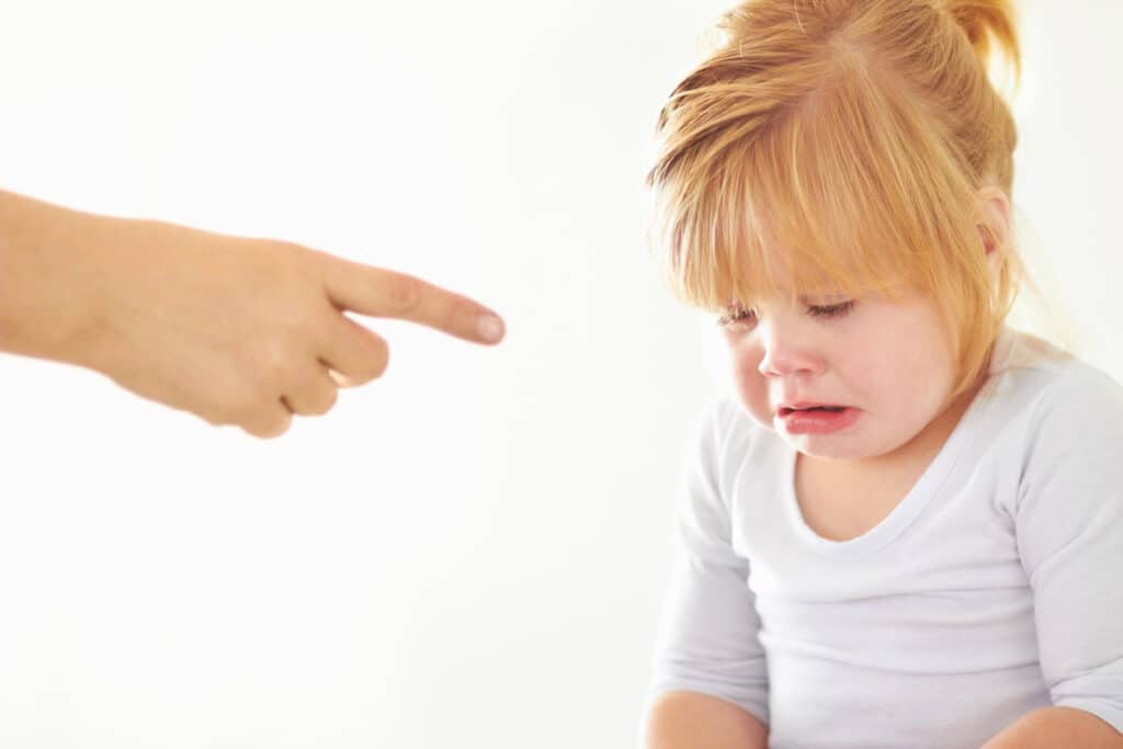 things you should never say to your child - parent admonishing baby girl with a pointing finger