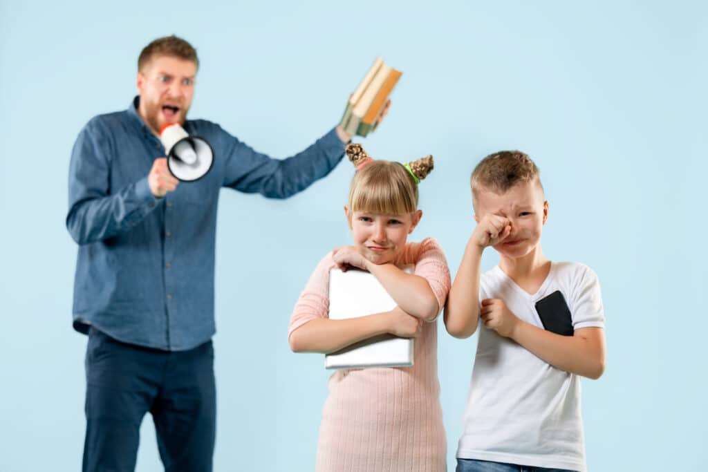 parent yelling at child - dad screming in a microphone at his two crying kids
