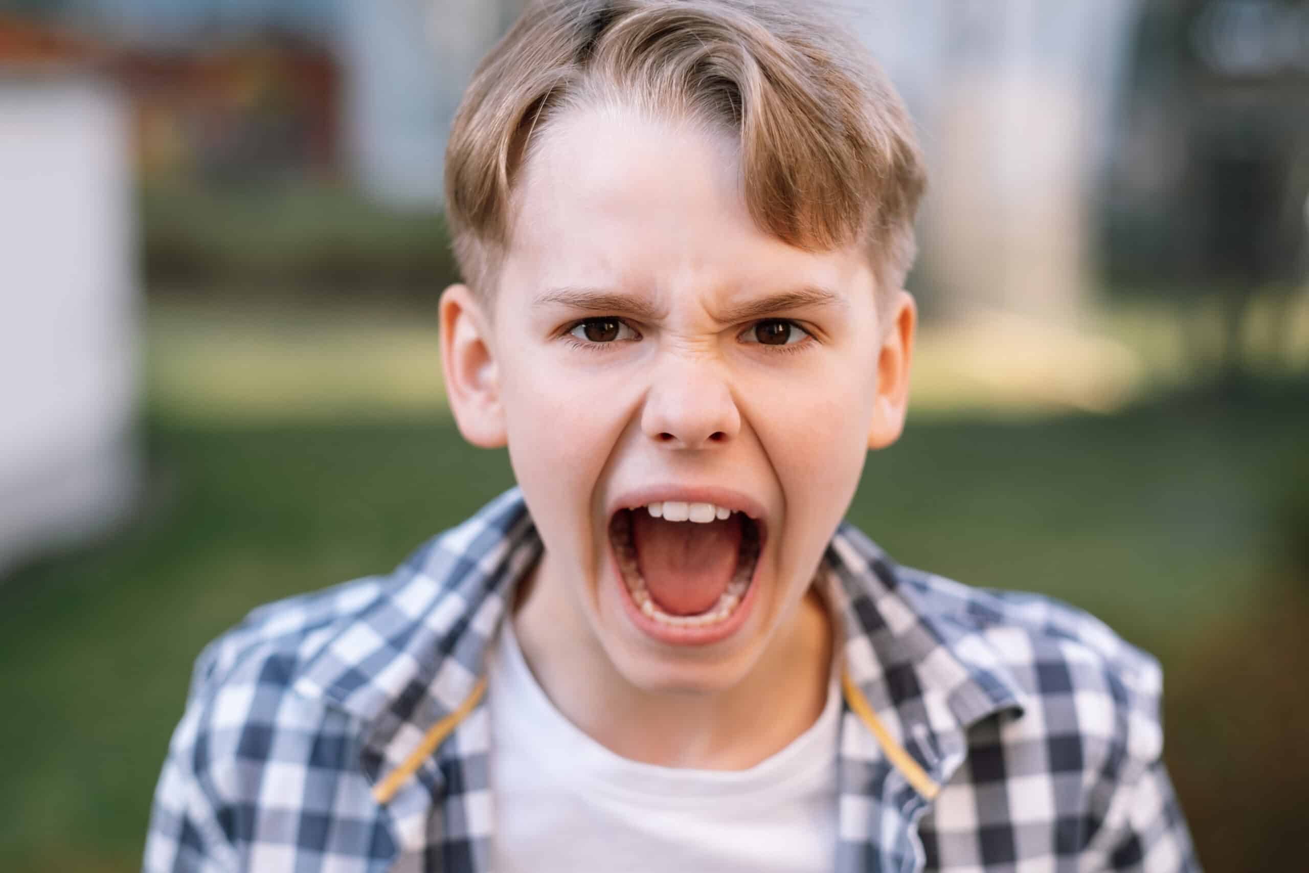 Boy yelling, a typical sign of anger issues.