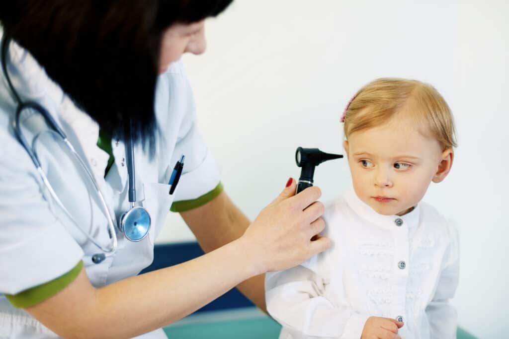 Toddler being examined by a doctor.